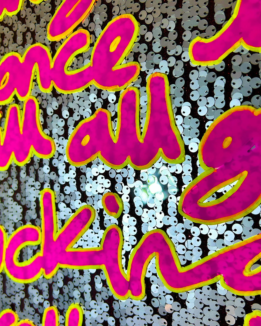 Fucking excellently. Pink & yellow ink over muted silver sequins.