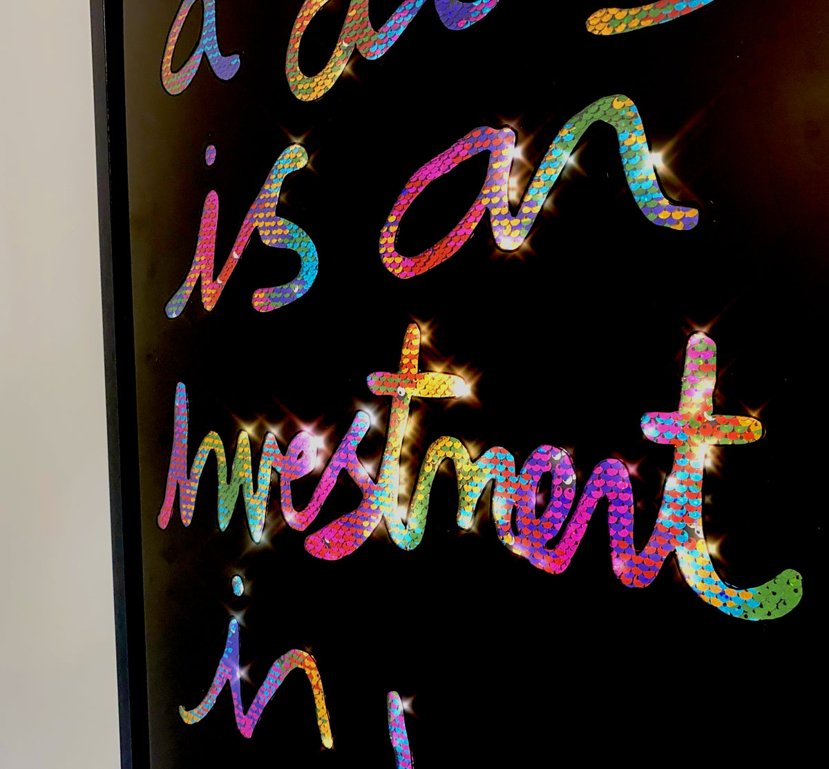 Investment in joy, Stencil black ink over multi coloured sequins.