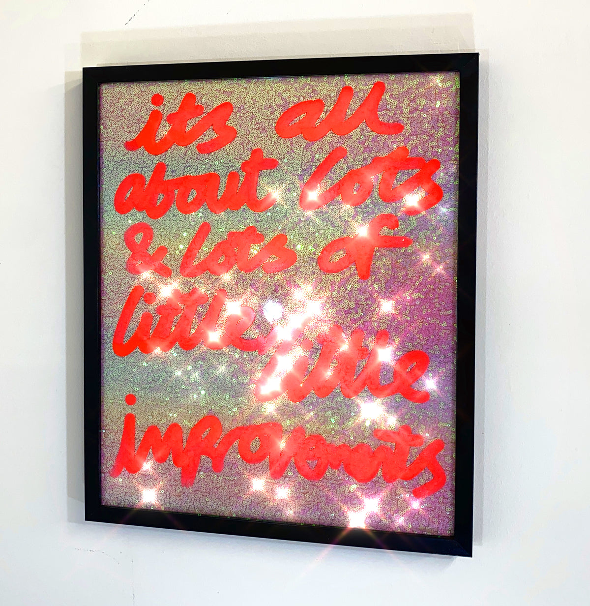 Little improvements, neon orange over white/subtle gradient sequins.