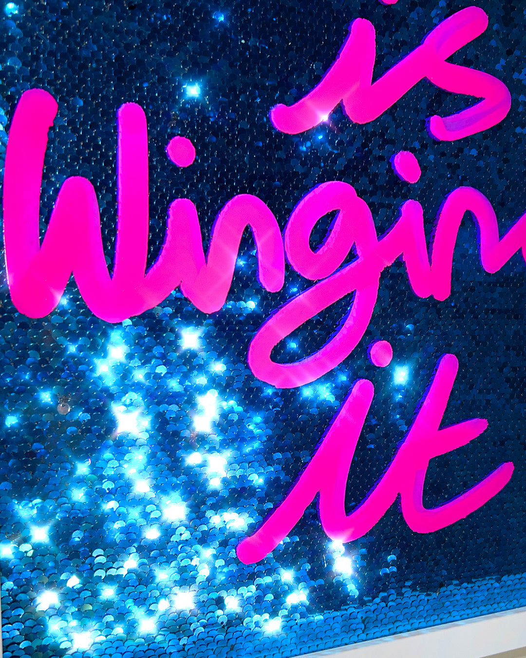 Winging it. Pink ink over blue sequins. Medium.
