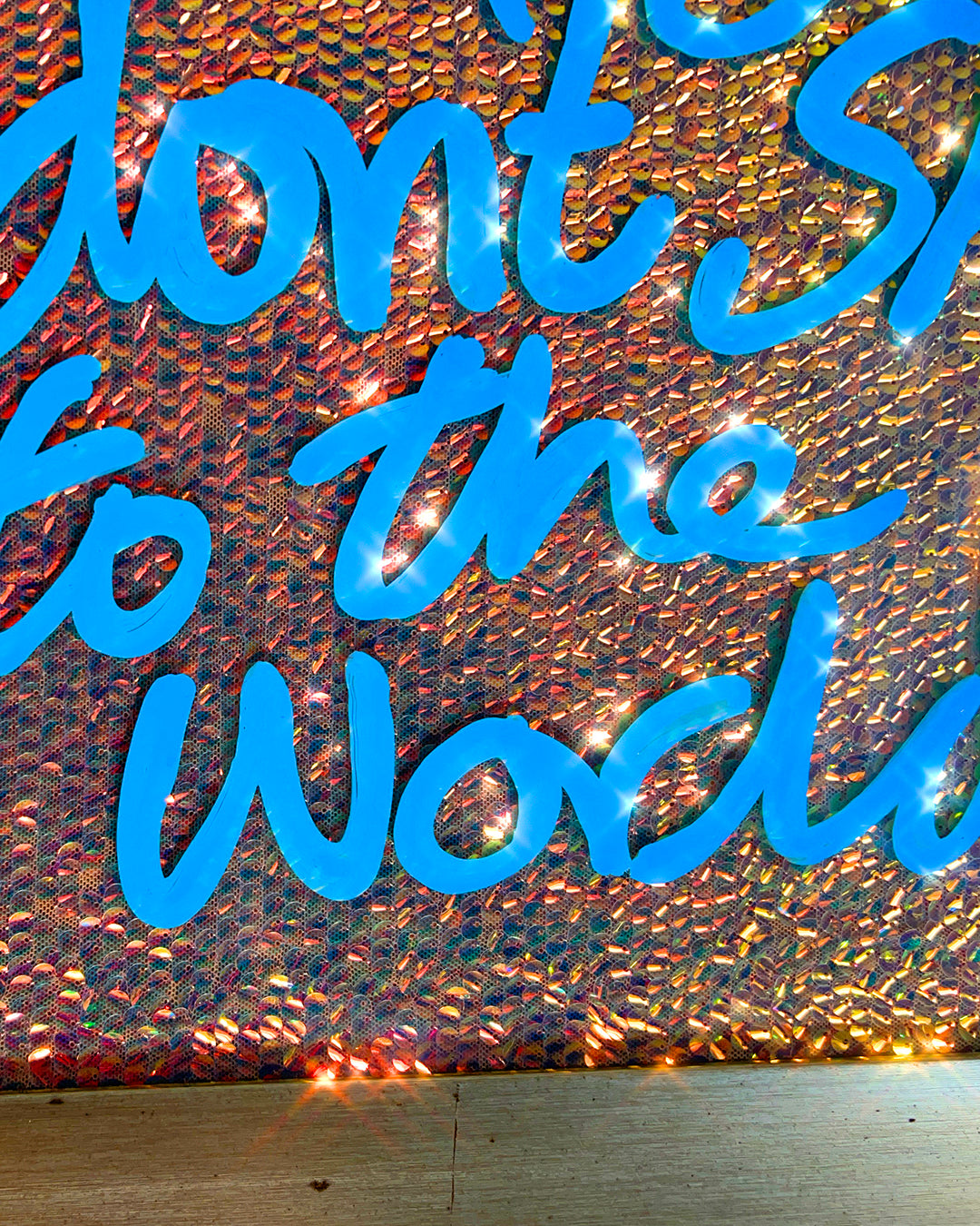 The side you don't show. Sky blue ink over iridescent warm gold. Medium