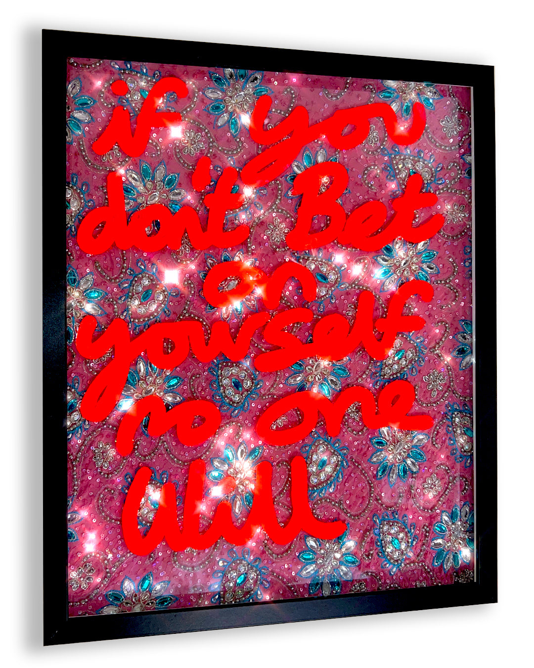 Bet on yourself. Fluorescent orange ink over pink, blue and silver bejewelled fabric.