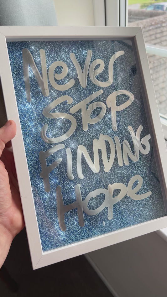 Finding hope. Liquid chrome over blue sparkling fabric. Extra Small.